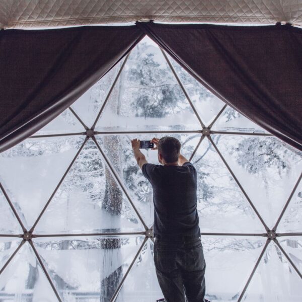 Man enjoying geo dome in winter